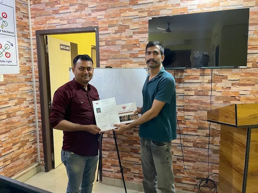 RPAS Pilot Logbook and certificate handed over to a graduate at the Aeropioneer office