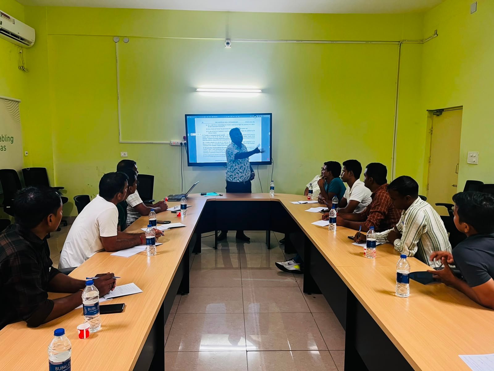 Instructor teaching a classroom theory session to remote pilot trainees