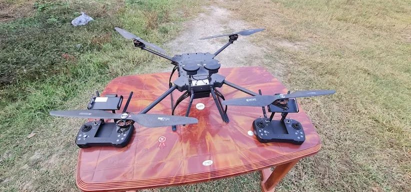 Close-up of a rotorcraft drone with two controllers on a table