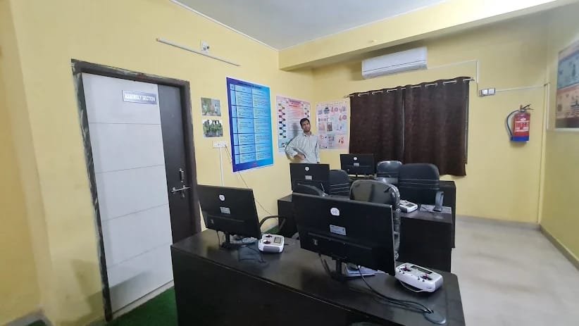 Simulator and assembly lab with flight-simulator controllers set up on desks
