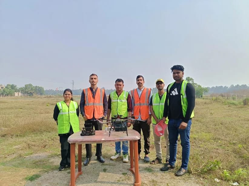 Field training team standing with a rotorcraft drone at an open airfield