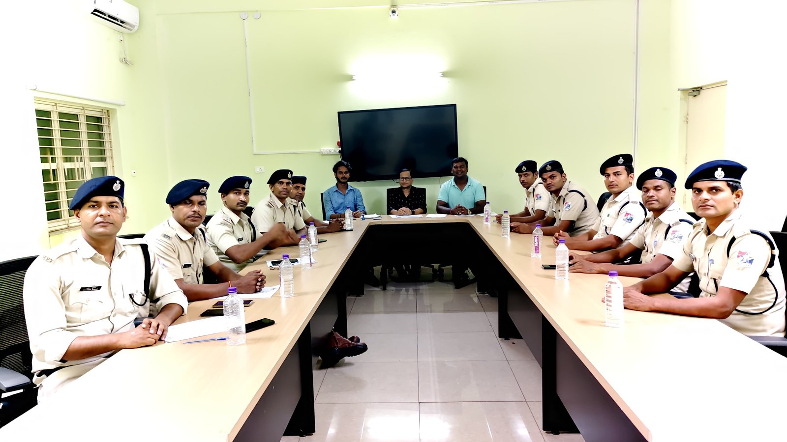 Classroom drone training session with Railway Protection Force officers seated around a conference table